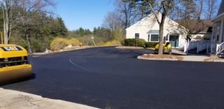 Fresh asphalt road fronting residential property